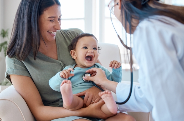 Mother, baby and stethoscope of pediatrician for healthcare consulting, check lungs and breathing for heartbeat. Doctor, happy infant kid and chest assessment in clinic, hospital and medical analysis