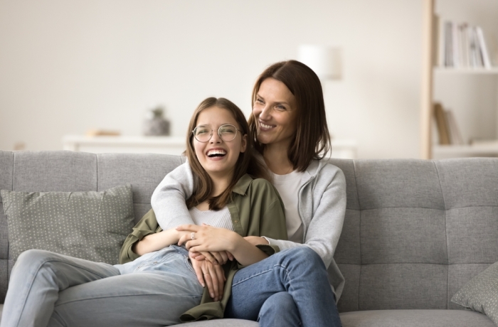 Happy mom and teenager daughter home casual portrait.