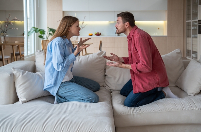 Angry emotional couple shouting, screaming, blaming each other. Scandal between annoyed irritated wife and defensive husband.