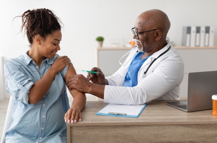 pregnant woman being vaccinated by doctor