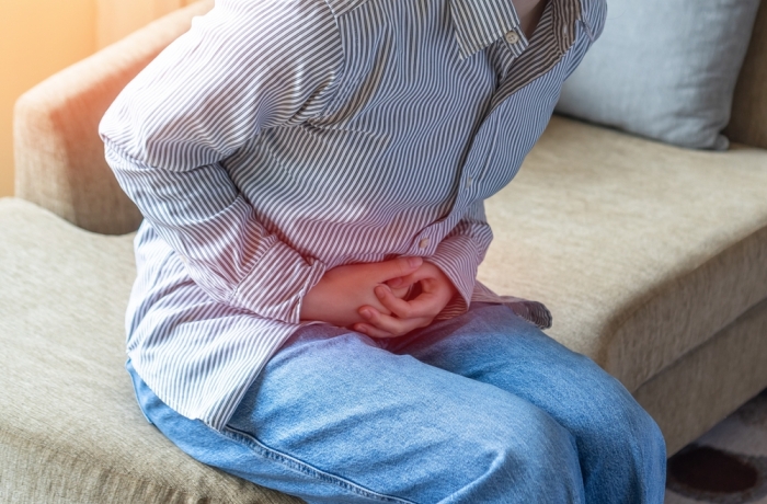 Abdominal pain in young woman with stomachache illness, menstruation cramps, stomach cancer, irritable bowel syndrome, pelvic discomfort, Indigestion, Diarrhea or GERD gastro-esophageal reflux disease