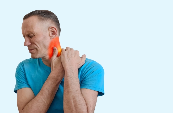 Young man feeling pain and massaging red sore neck, Male clutching sore neck, graphic red area emphasizes inflammation and muscle discomfort.
