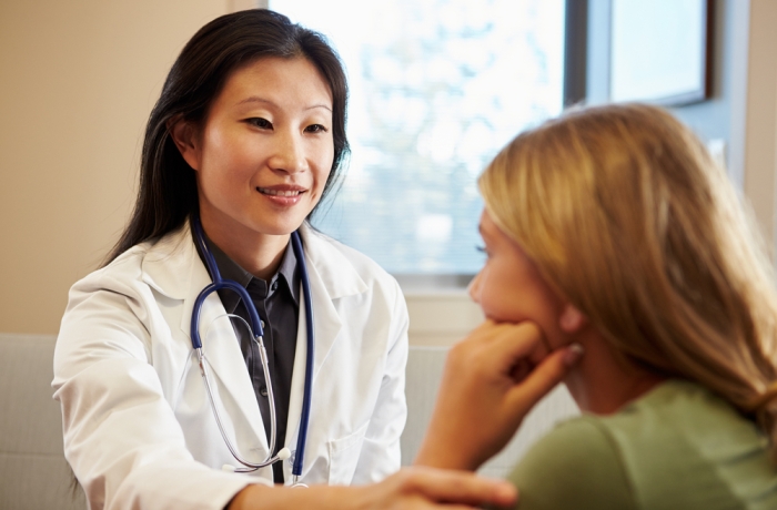 Doctor Treating Teenage Girl