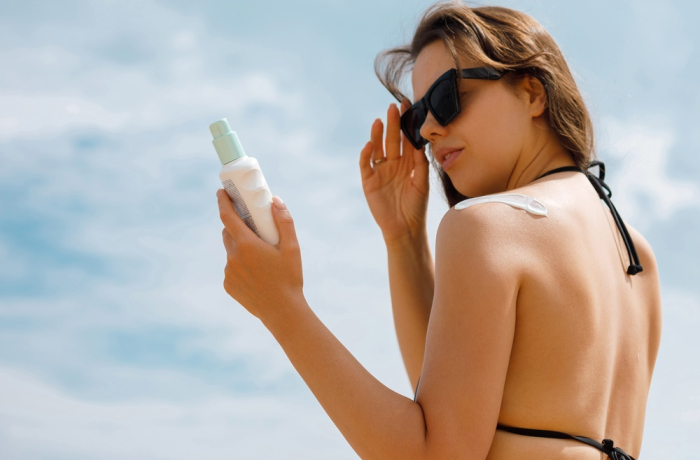 women looking at sunscreen lotion