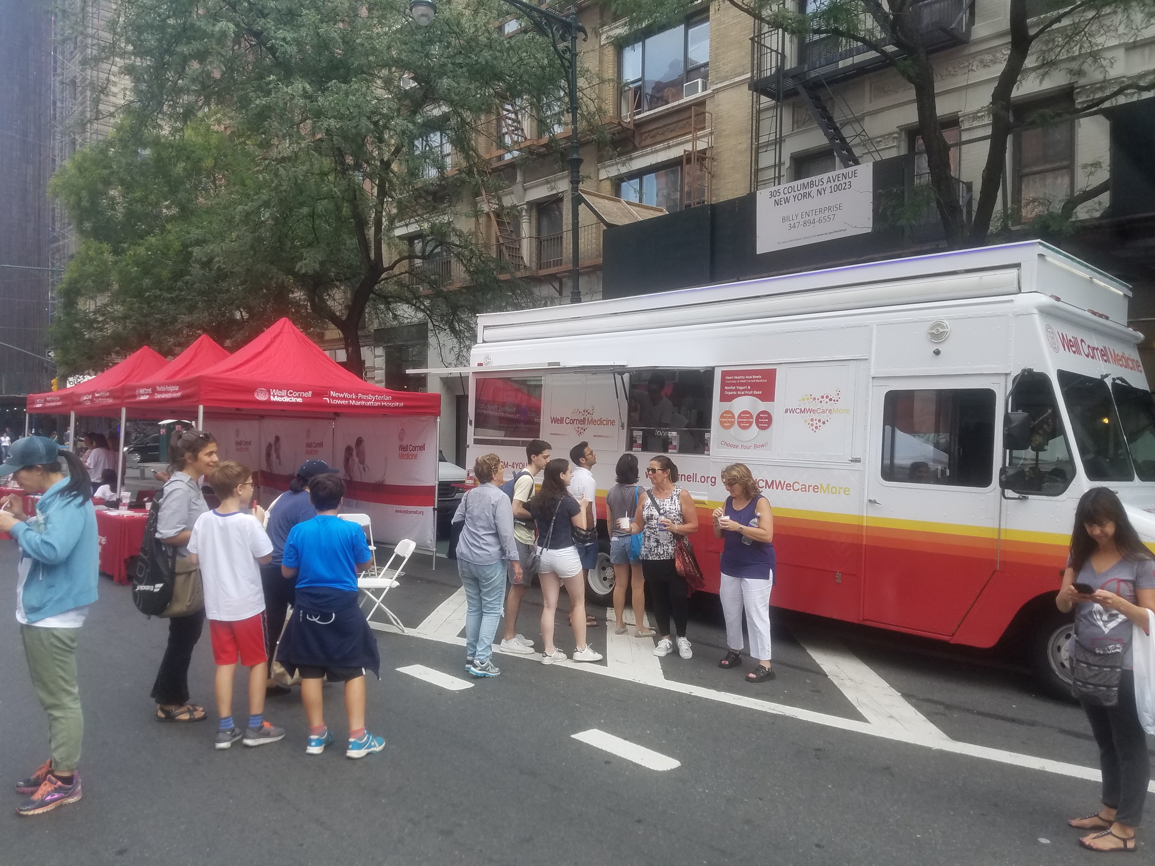 Columbus Avenue Festival attendees lined up for healthy snacks in front of Weill Cornell Medicine's food truck.