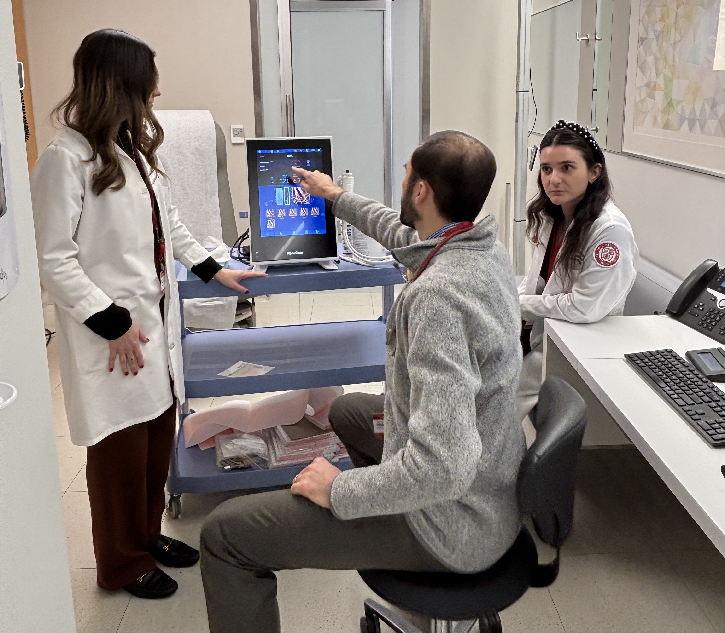 ICHANGE team members review the results from a FibroScan.