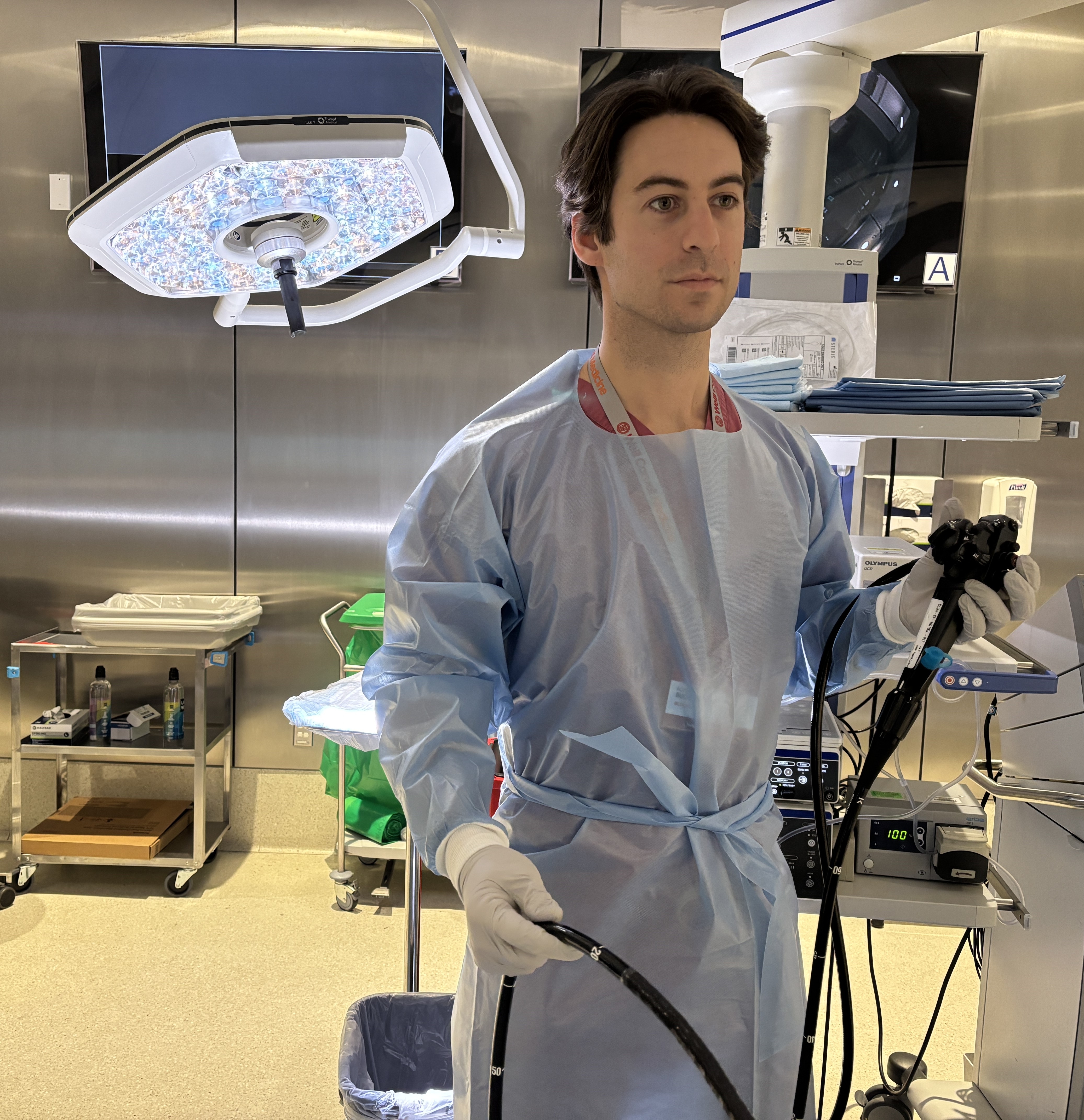 Dr. Adam Buckholz uses a scope during an endoscopy.