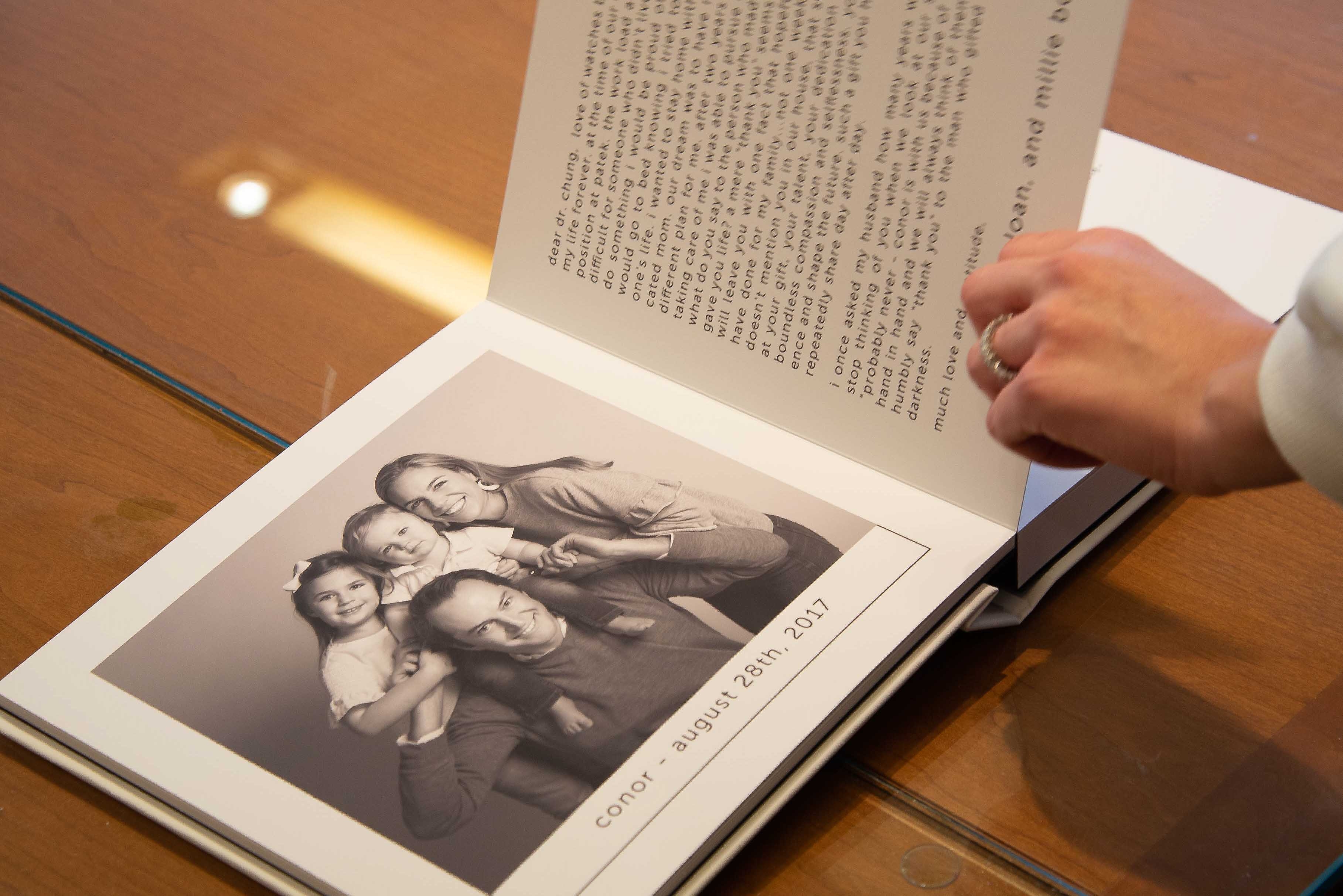 Dr. Chung looks through an album gifted by former patients.