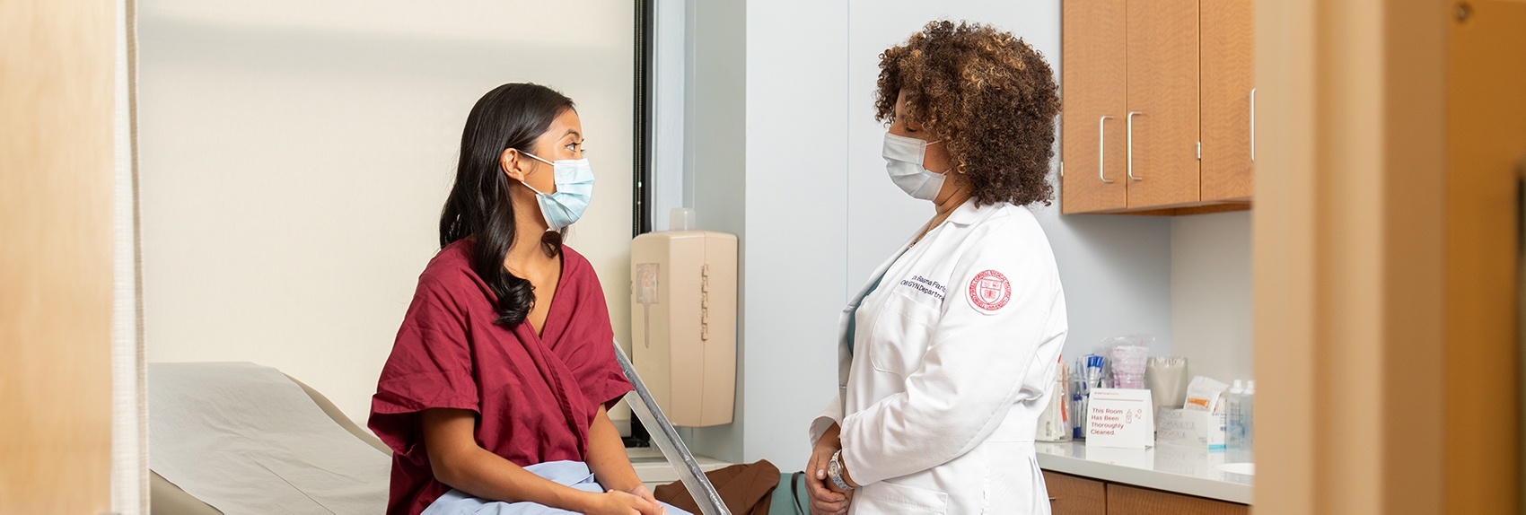 Weill Cornell Medicine doctor talking to female patient in exam room.