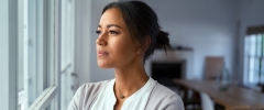 woman looking pensive out of window