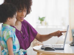 Mom and child looking at a laptop