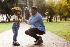 Father adjusting a bicycle helmet on his son