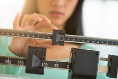 Close-up of a woman adjusting a scale