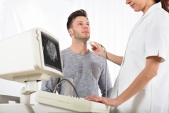 Man receiving an ultrasound of his thyroid