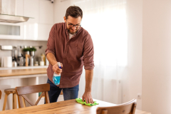 A man cleaning the table