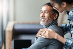 older patient with woman's hand on shoulder