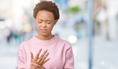 woman over isolated background Suffering pain on hands and fingers,