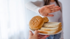 Young woman on gluten free diet is saying no thanks to toast