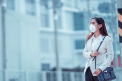 Asian woman are going to work.she wears N95 mask.prevent PM2.5 dust and smog
