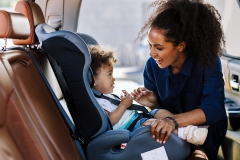 mom with child in car seat