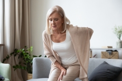 Elderly 60s woman got up from couch felt severe painful feelings