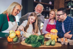 Happy family cooking together at home and smiling