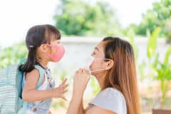 mom and daughter heading back to school and wearing masks