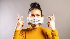 women holds mask over her face