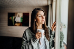 woman looking outside window