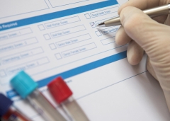 Doctor ticking box on a blood test form