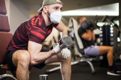 man working out at the gym with mask on