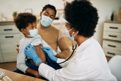 black doctor checks patients heart