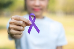 child holding purple ribbon