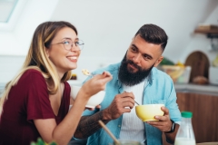 Shot of a young couple enjoying breakfast in the kitchen
