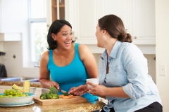 Two Women Preparing Vegetables in Kitchen