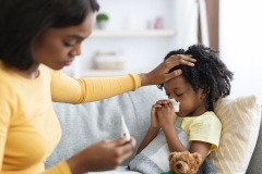Worried Black Mom Taking Care Of Her Ill Child At Home