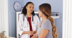 black female doctor meets with female patient