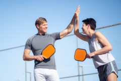  Laughing couple playing pickleball game