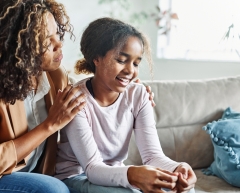 Mother with her teenage daughter at meeting with social worker, psychologist discussing mental health family sitting on sofa in psychotherapist office