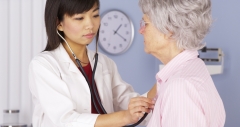 doctor checks on patient's heart