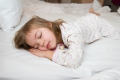 young child sleeping in bed