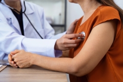 Doctor listens to heartbeat of older of retirement age to check their heart rate