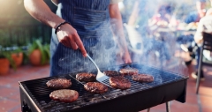 Barbecue, cooking and man with burgers outdoor backyard for meal at reunion, social event or lunch on terrace.
