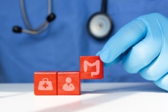 Doctor arranges wooden cubes. Concept of intestinal problems, colon cancer, bacteria and viruses.