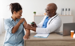pregnant woman being vaccinated by doctor