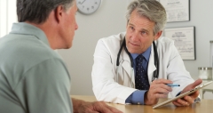 male patient speaks with male doctor