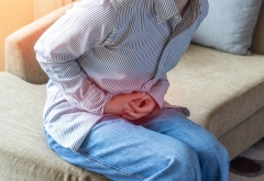 Abdominal pain in young woman with stomachache illness, menstruation cramps, stomach cancer, irritable bowel syndrome, pelvic discomfort, Indigestion, Diarrhea or GERD gastro-esophageal reflux disease