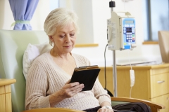 Senior Woman Undergoing Chemotherapy With Digital Tablet