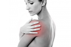 Woman pressing her hand on painful shoulder
