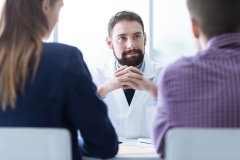 Young couple at the doctor's office during a visit, medical advice and consultation concept